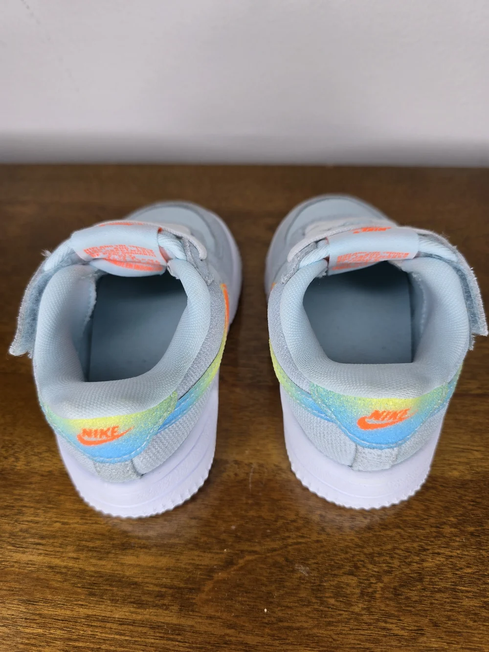 Nike Kids' Light Blue Sneaker with Orange Accents